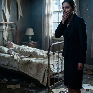 I came home from a business trip expecting silence, not a note from my husband: “Take care of the old woman in the back room.” When I opened that door, I found his grandmother barely alive. Then she grabbed my wrist and whispered, “Don’t call anyone yet. First, you need to see what they’ve done.” At 8 AM the next morning, the doorbell rang. When my husband opened it, his arrogant face turned pale. He thought I was a naive pushover. He didn’t know I was…